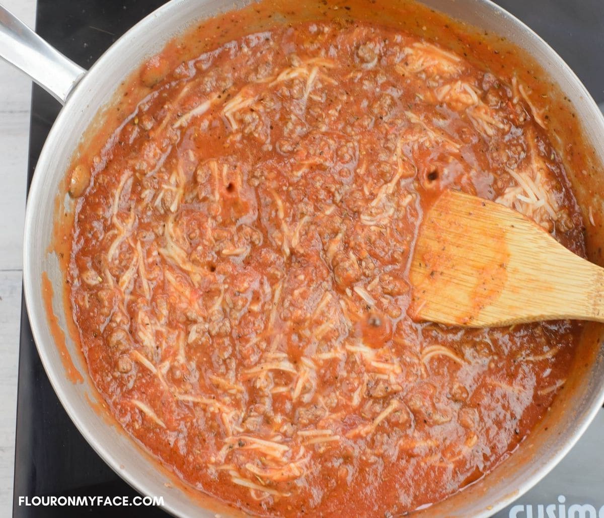 Simmering homemade pasta sauce in a large skillet.