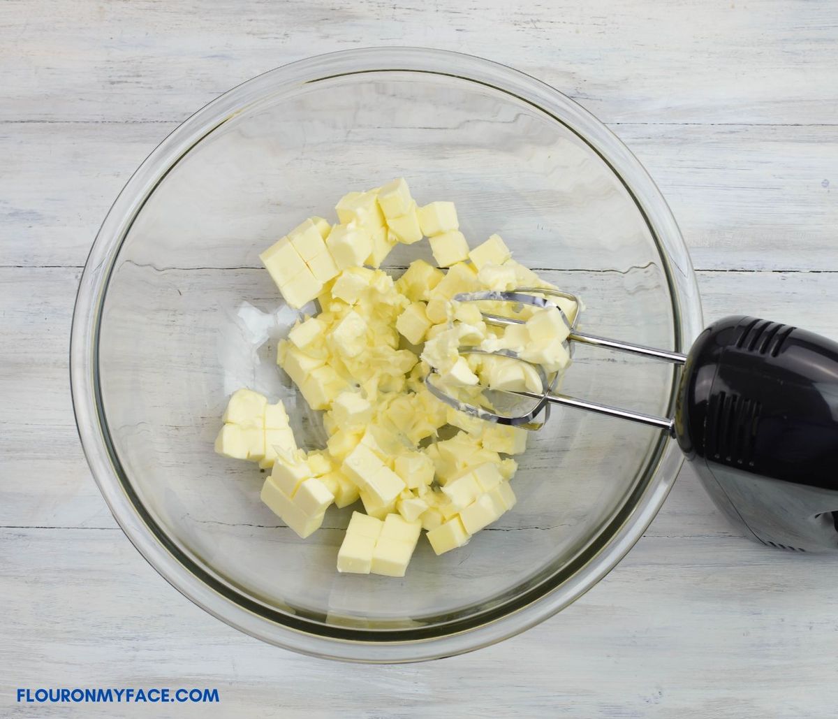 Cubed softened butter in a large bowl.