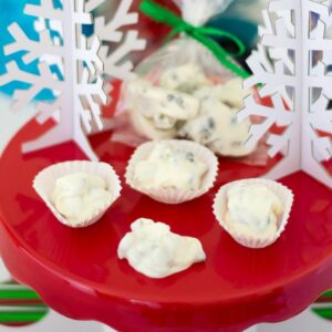 White chocolate dried fruit clusters served on a red cake stand for Christmas.