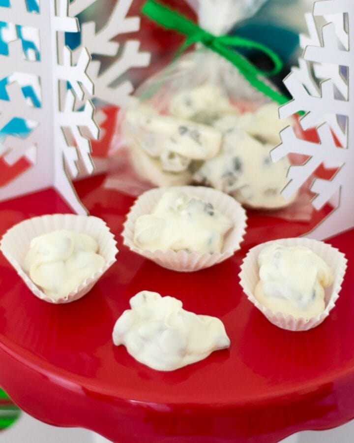 White chocolate dried fruit clusters served on a red cake stand for Christmas.