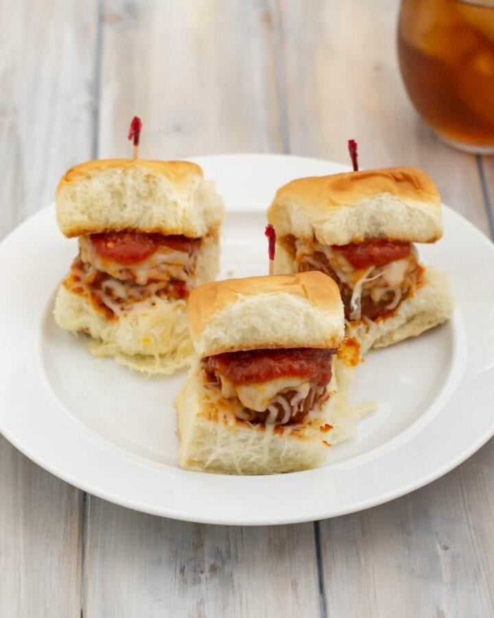 A white plate with 3 sliders made with homemade meatballs.