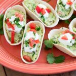 Mini Guacamole Boats appetizers on a serving platter.