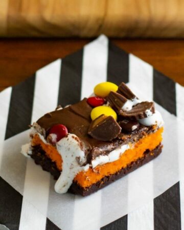 Halloween Brownie Cake bars on a black and white napkin.