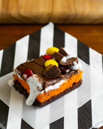 Halloween Brownie Cake bars on a black and white napkin.