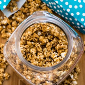 Overhead image of a glass candy jar filled with homemade caramel corn.