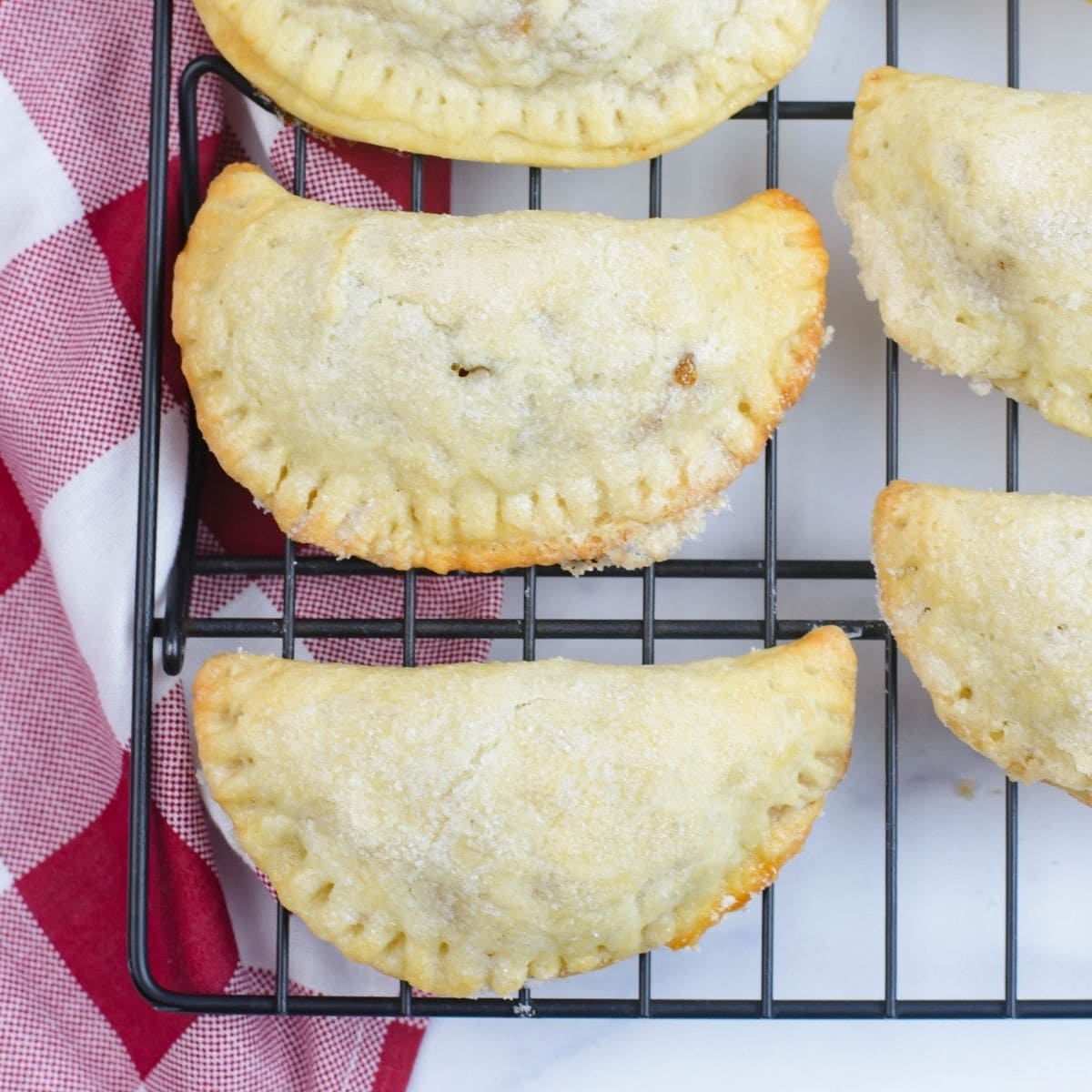 Golden apple cranberry turner overs cooling on a wire cooling rack.