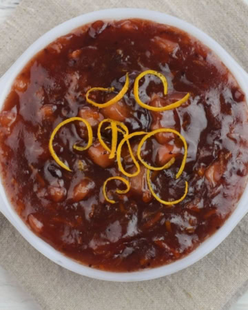 A serving dish filled with homemade apple cranberry compote.