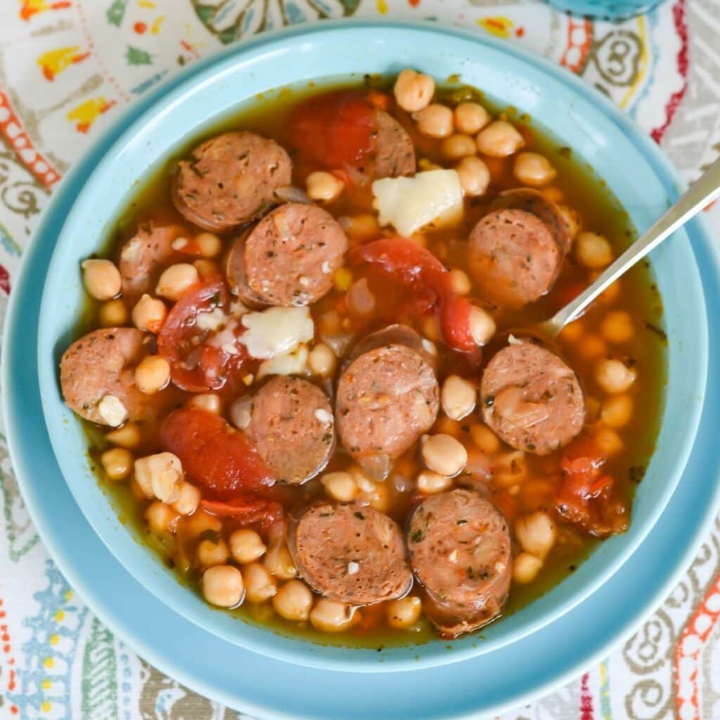 Sausage Garbazo Bean Soup in a bowl on a place mat.