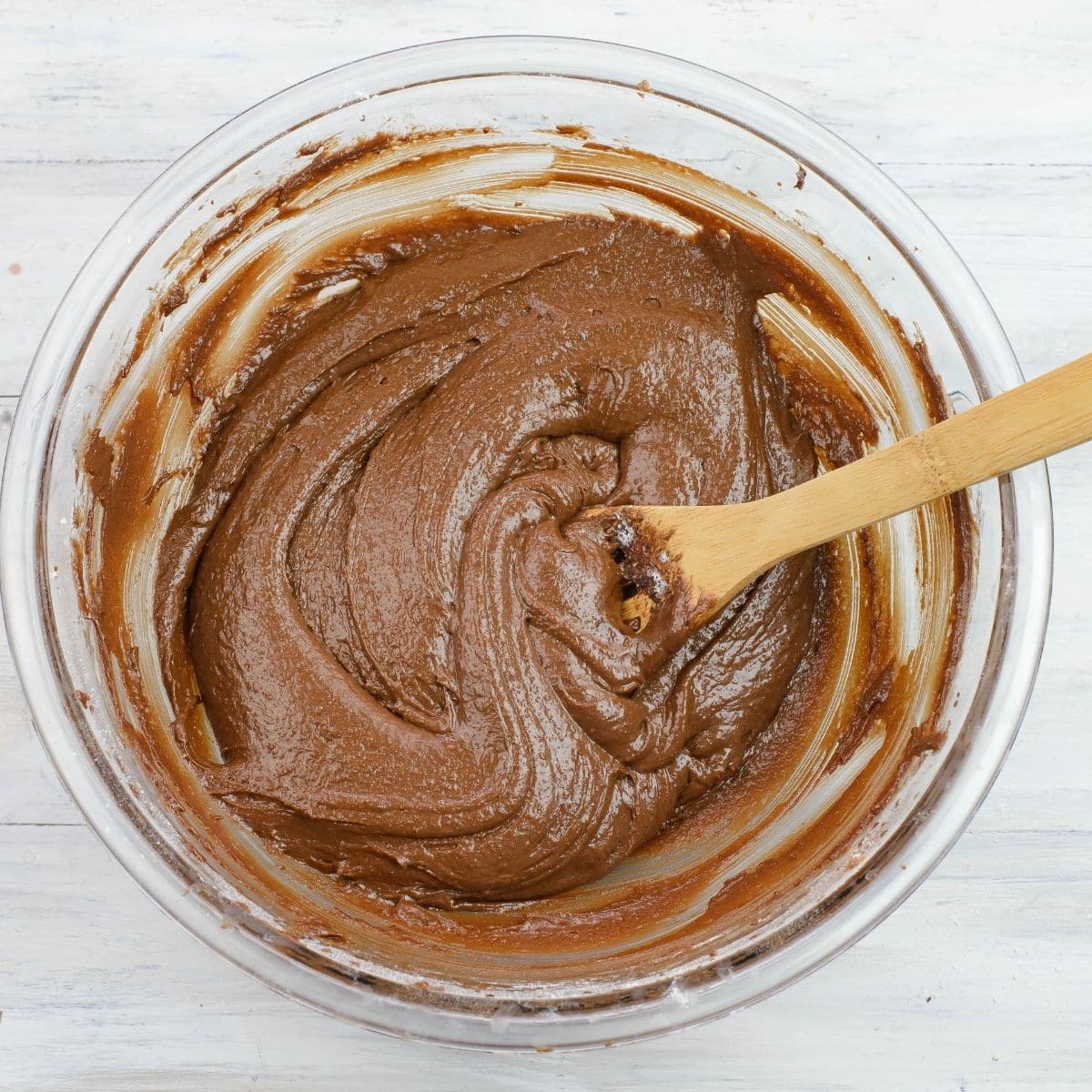 A large mixing bowl filled with chocolate crinkle cookie batter.