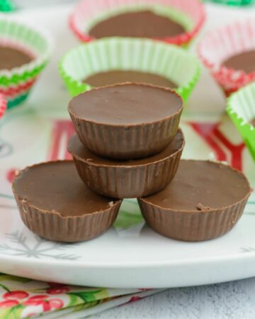 Homemade Mounds Candy Bites in holiday cups on a plate.