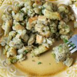 A serving of homemade bread stuffing on a plate.