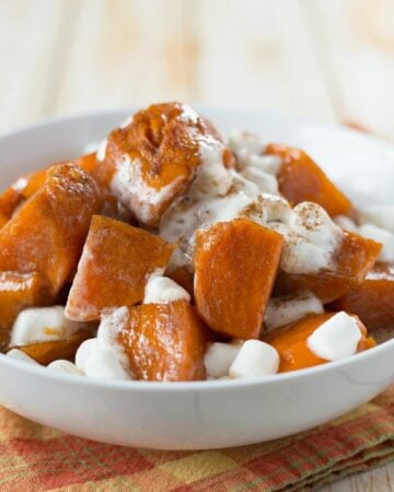 A bowl of sweet and tender Instant Pot Sweet Potatoes topped with marshmallows.