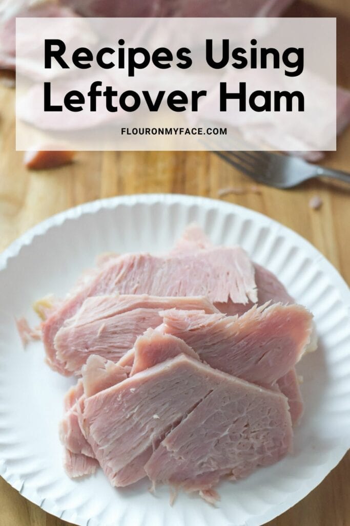 A long vertical image of leftover ham sliced on a paper plate.