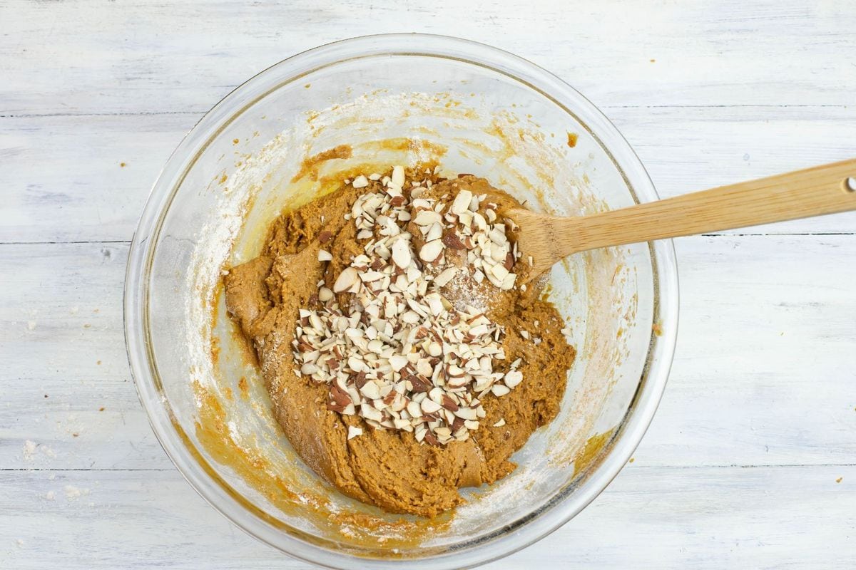 Mixing toasted almonds into German ginger bread cookie dough.