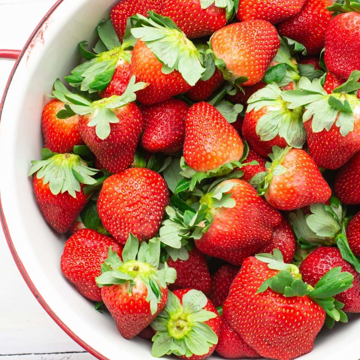 Fresh whole  strawberries in a colander.
