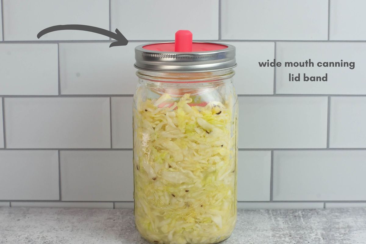 Canning jar and lids for fermenting cabbage.