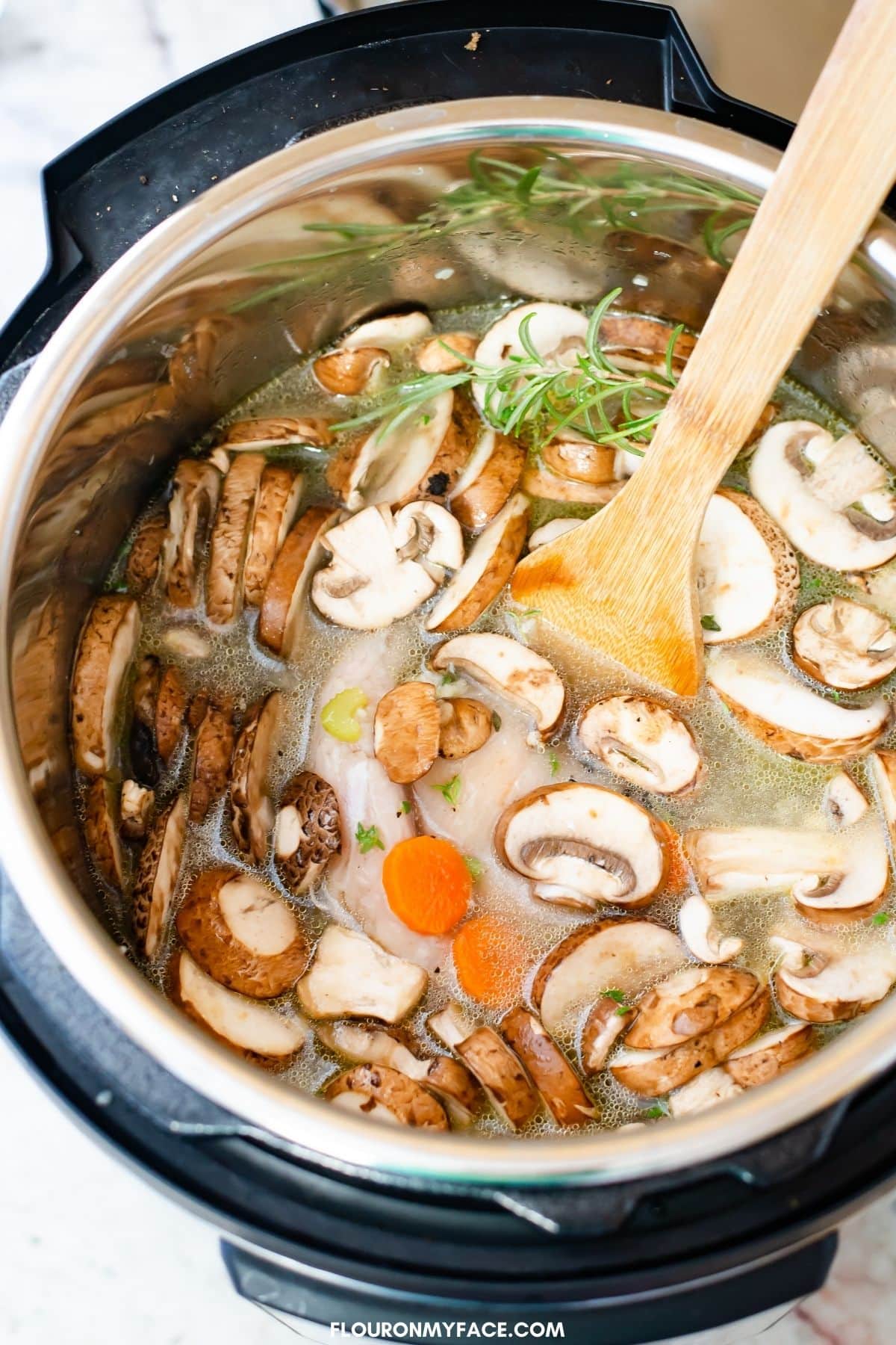 Instant Pot Chicken Wild Rice Soup recipe ingredients in the pressure cooker before cooking.