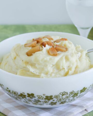 A large serving bowl filled with garlic roasted mashed potatoes.