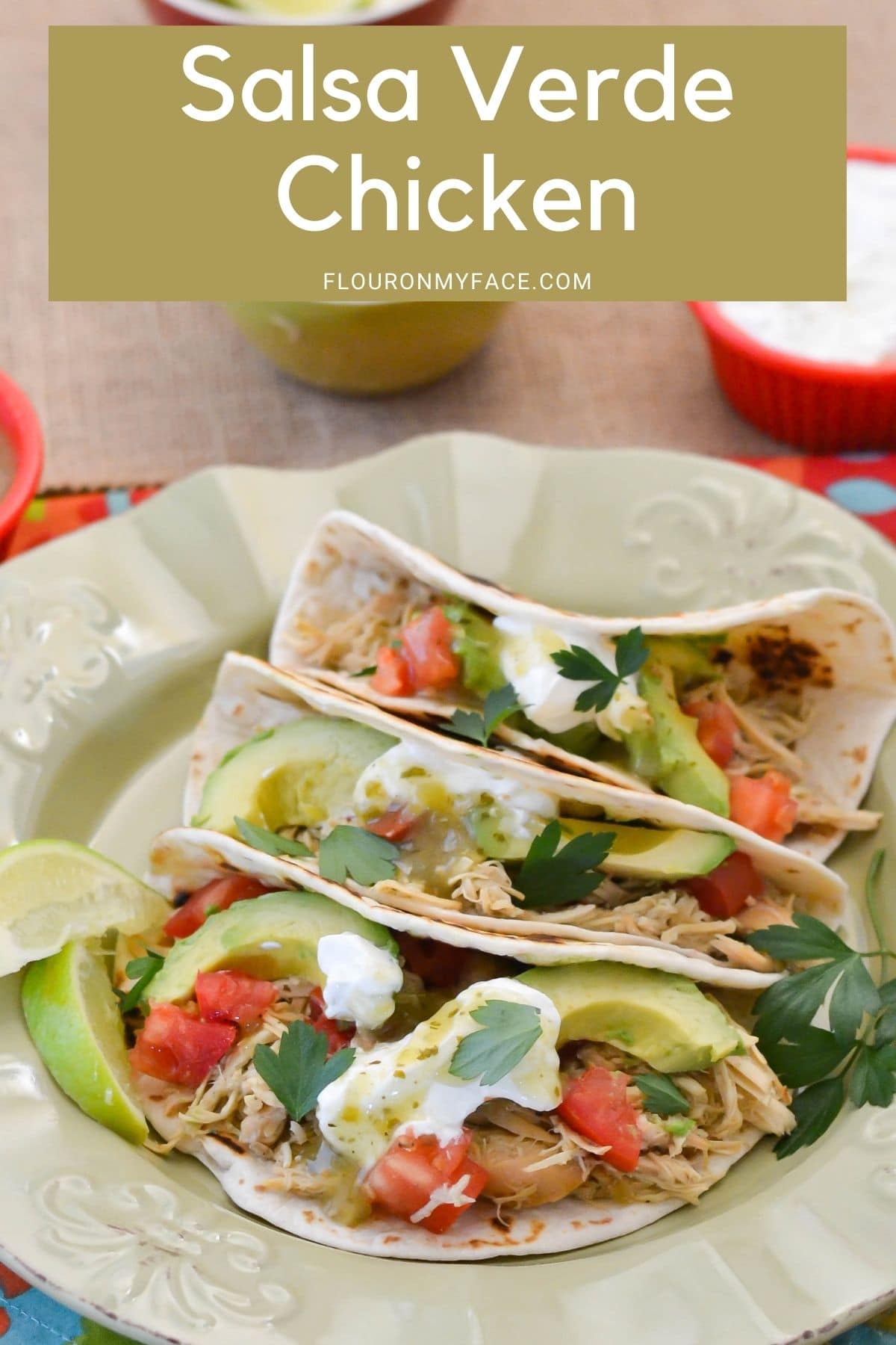 Crock Pot Salsa Verde Chicken Tacos with toppings on a plate.