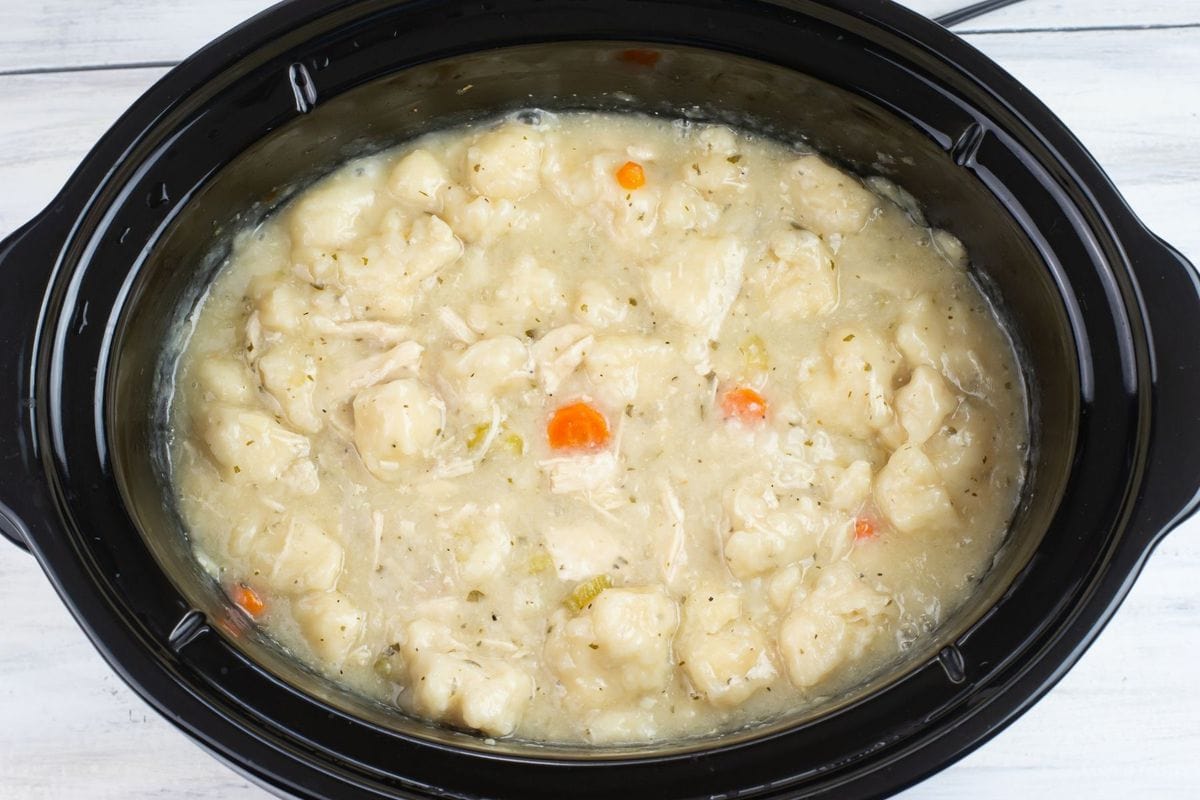 Overhead photo of the slow cooker chicken and dumplings recipe after the dumplings have cooked and floated to the top of the broth.