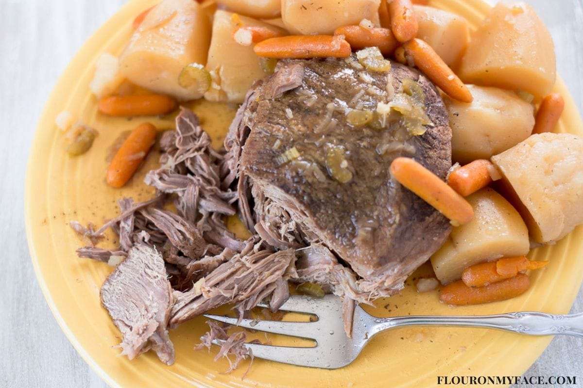 Crock Pot Pot Roast is moist and tender. Served with potatoes and carrots.