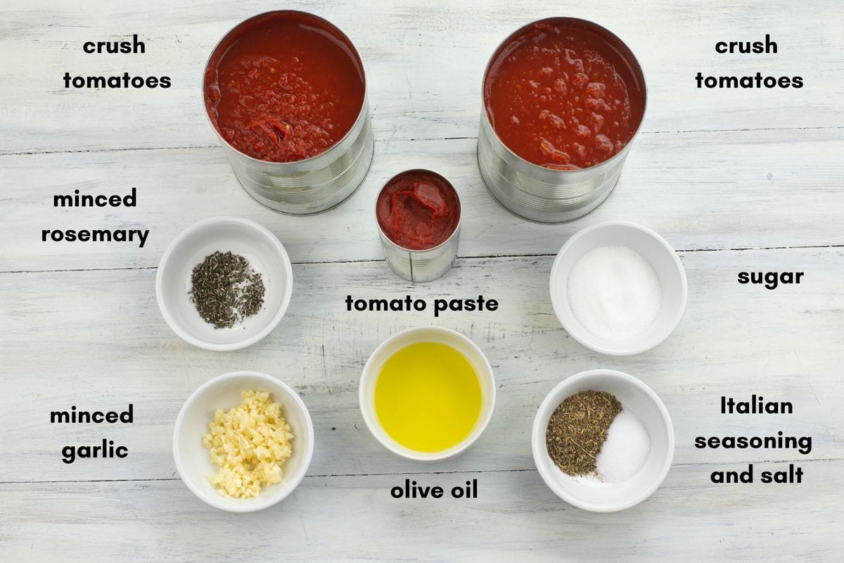 Individual pizza sauce ingredients, in small bowls and cans.