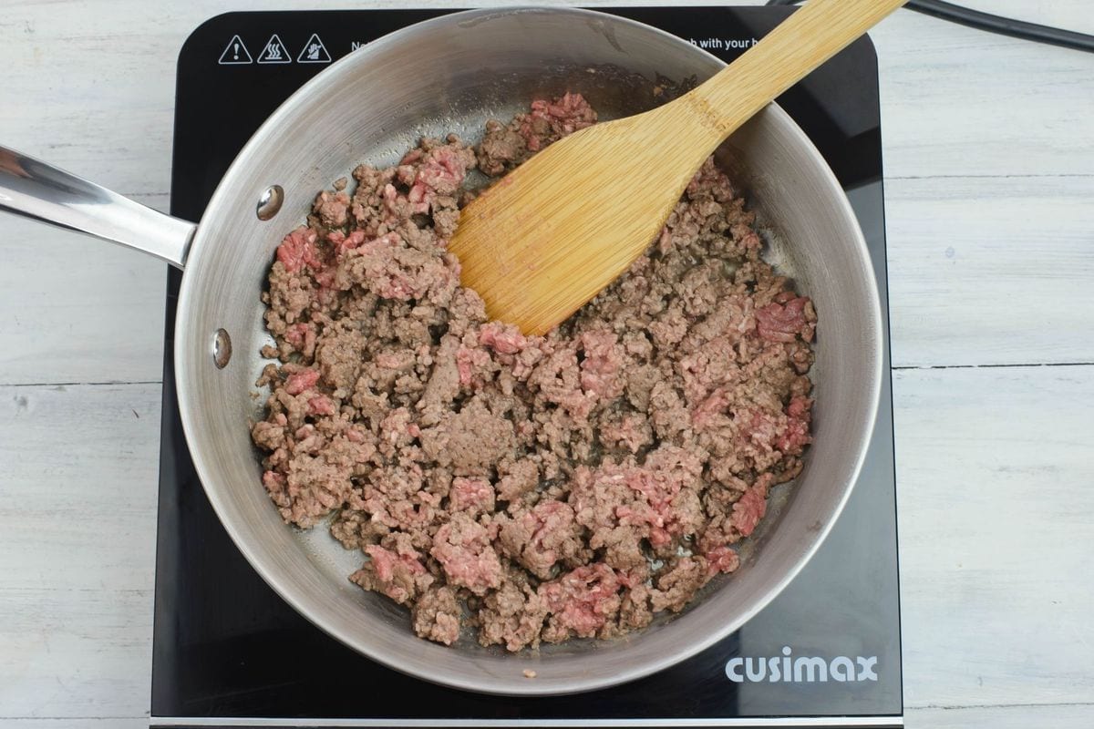 Cooking ground beef in a large skillet.
