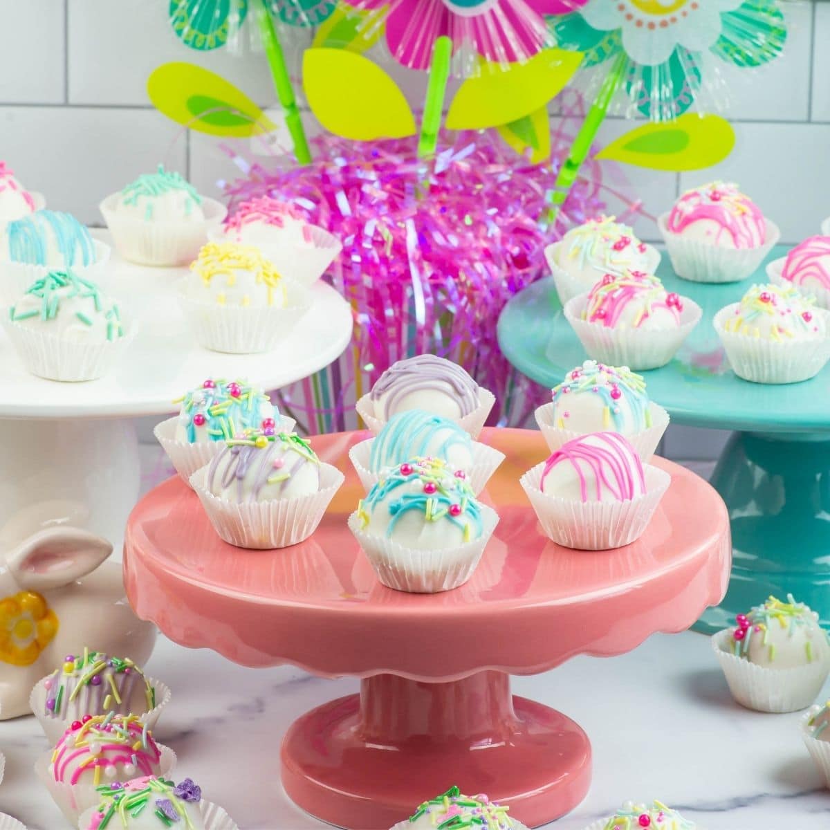 Easter Cake Balls on colorful cakes stands.