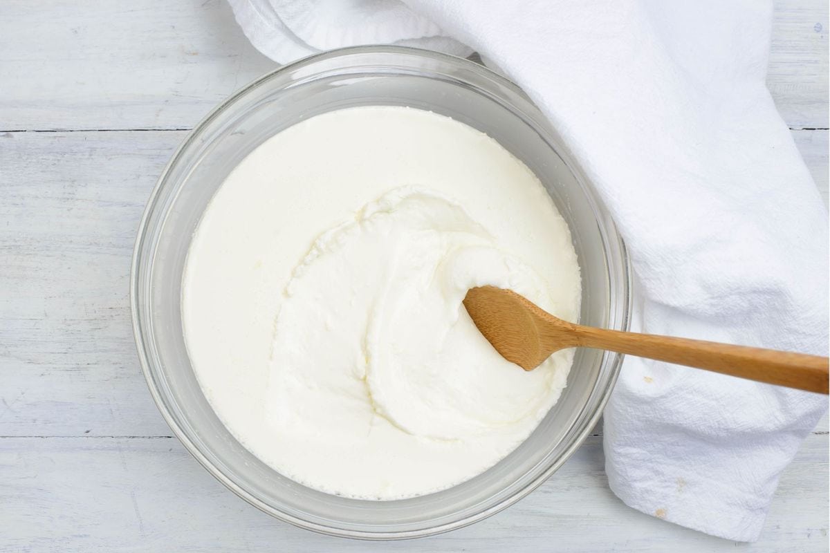 Image of a glass mixing bowl filled with thickened crème fraiche.