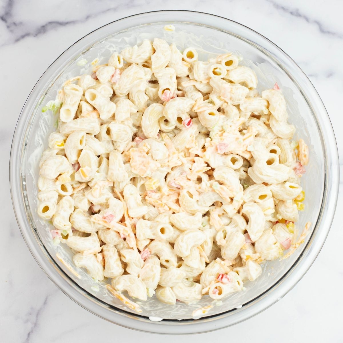 A large bowl filled with Sour Cream Cheddar Pasta Salad.