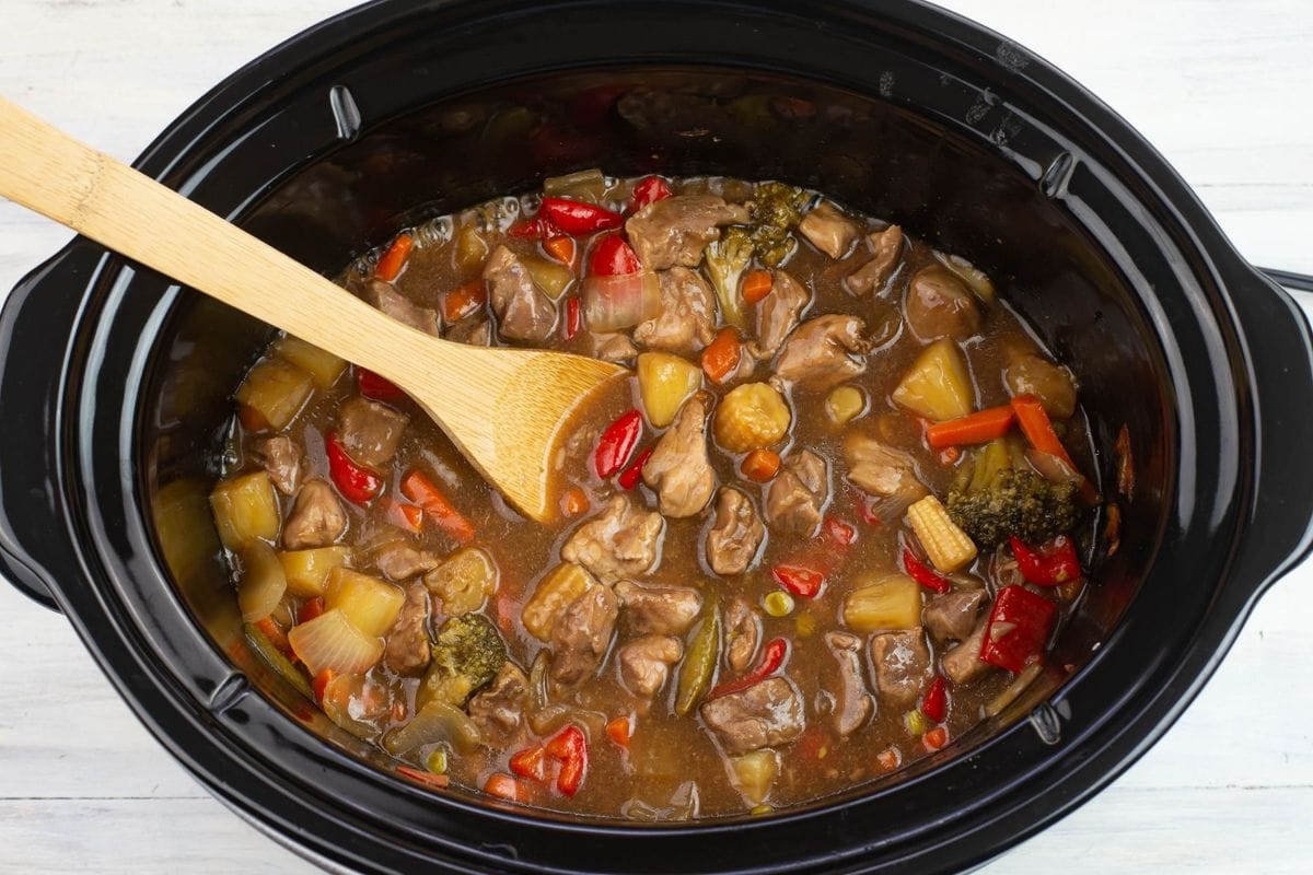 Cooked cubed pork and vegetables in a thickened sweet and sour sauce.