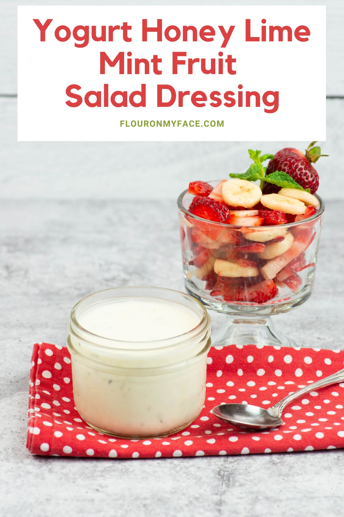 Fruit Yogurt Dressing in a mason jar with a bowl of fruit in the background.