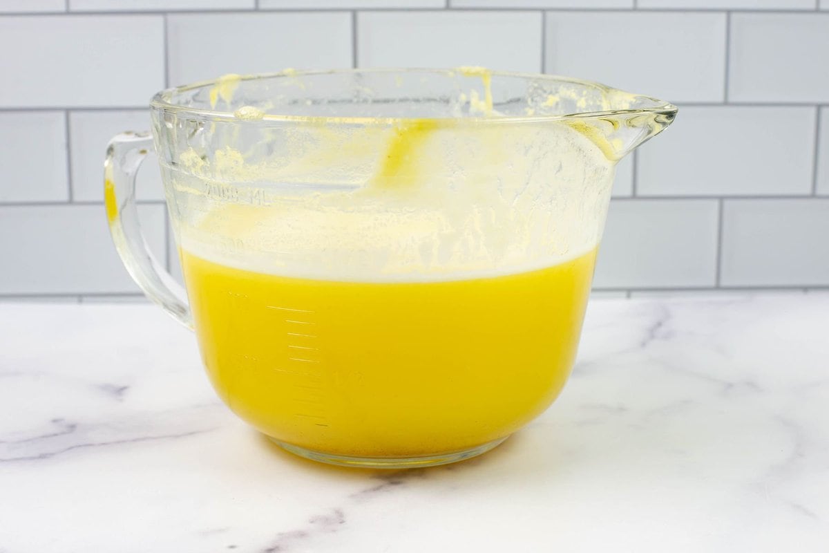 Homemade Pineapple juice in a large clear measuring bowl.