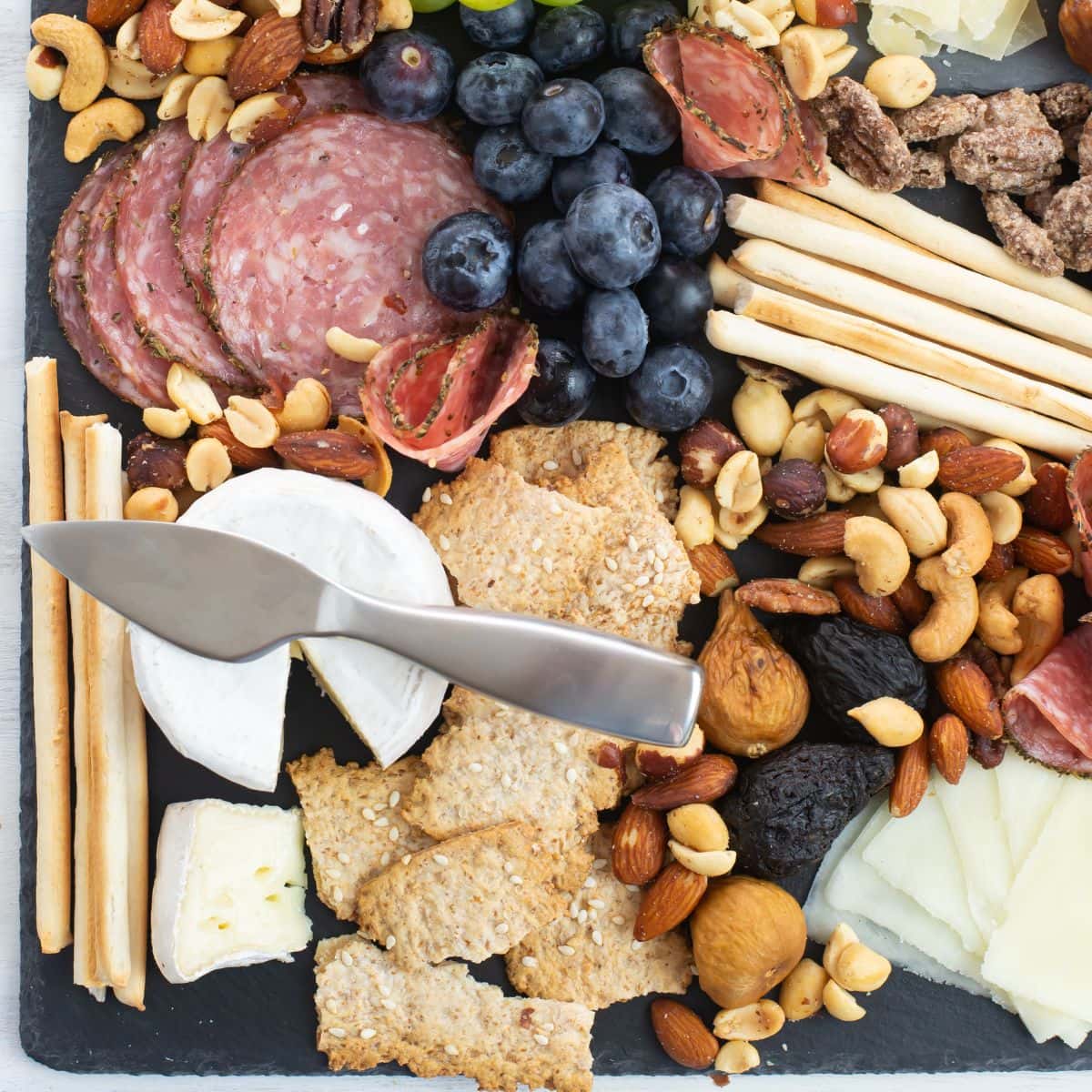 Image of a cheese platter covered with different appetizer options.
