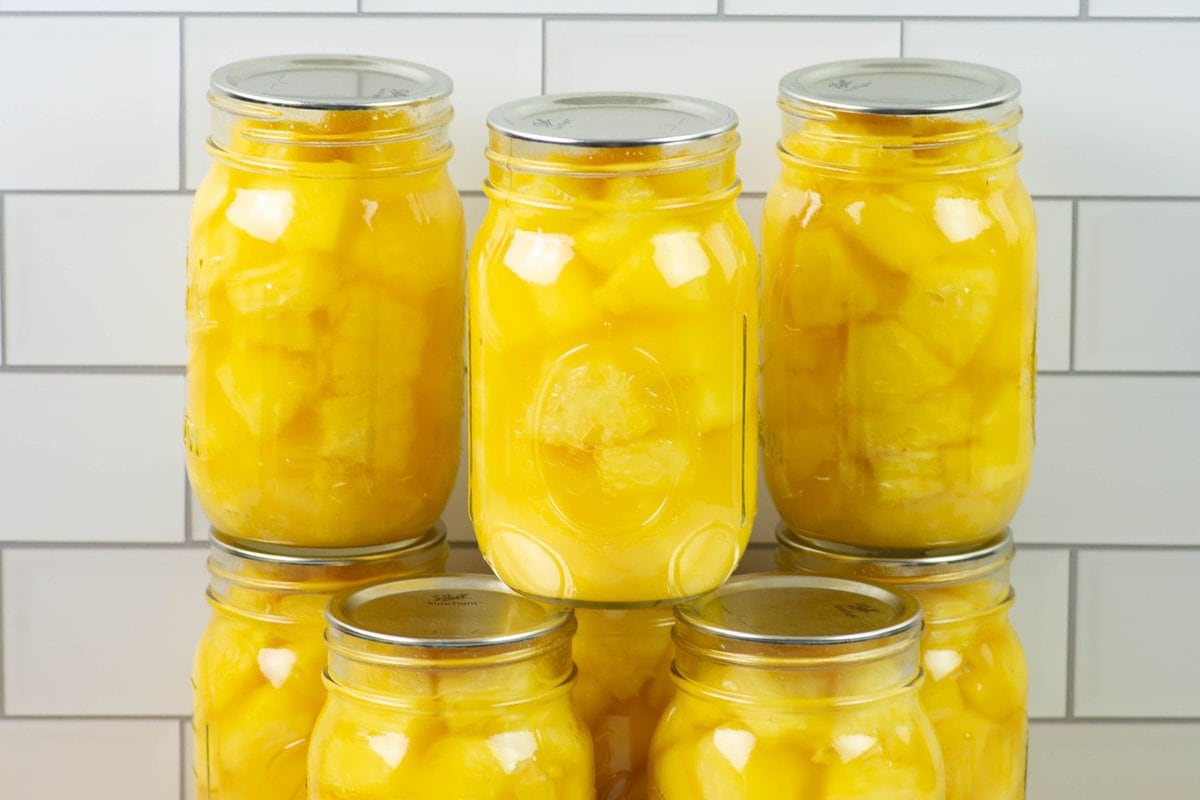 Home canned pineapple chunks in canning jars.