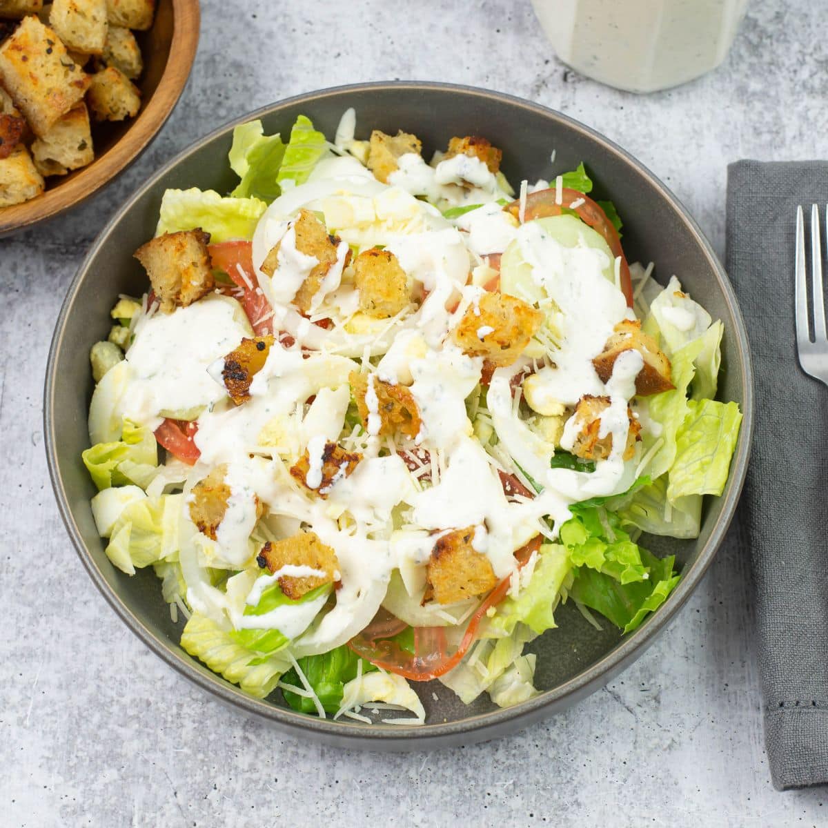 A large salad drizzled with homemade buttermilk ranch dressing.