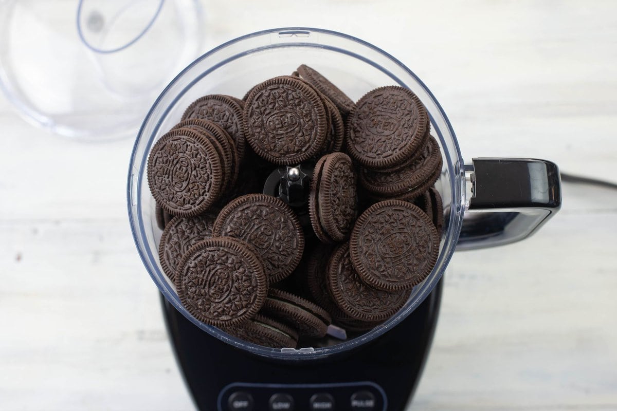 OREO sandwich cookies in a food processor before turning them into crumbs.