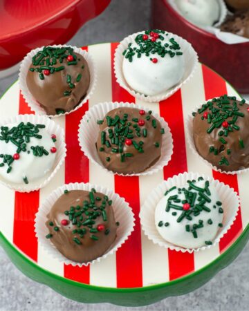 Peppermint Oreo Truffles in paper cups on a red, green and white mini cake stand.