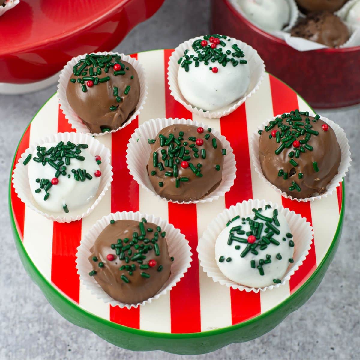 Peppermint Oreo Truffles in paper cups on a red, green and white mini cake stand.