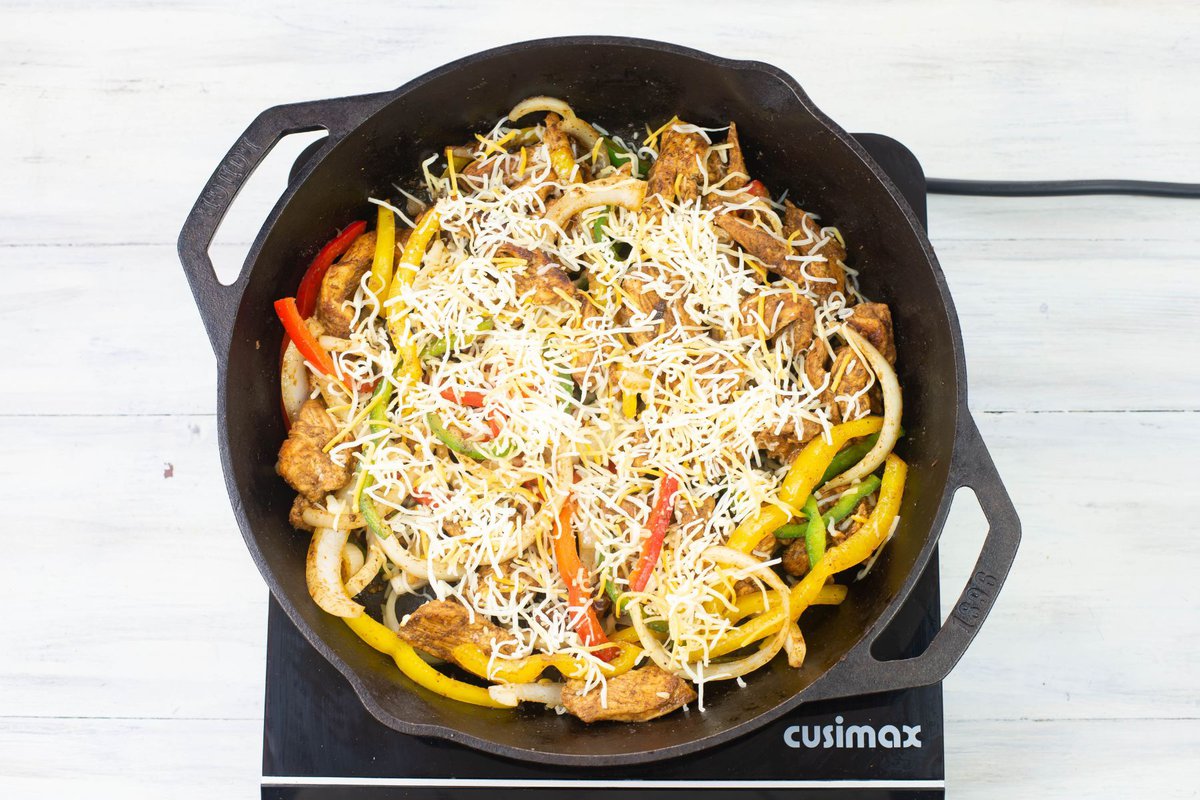 A skillet filled with the ingredients to make chicken fajitas for dinner in less than 30 minutes.