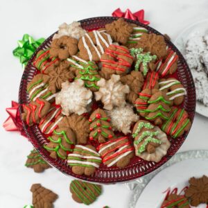Mocha Spritz Cookies piled on a decorative Christmas cookie stand.