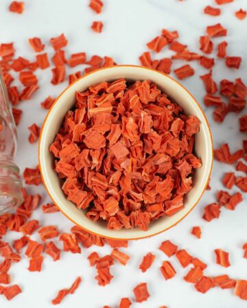 Dehydrated cubed carrots in a small round bowl.