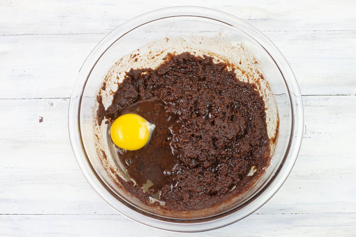 Adding one egg at a time as you whisk the brownie batter.