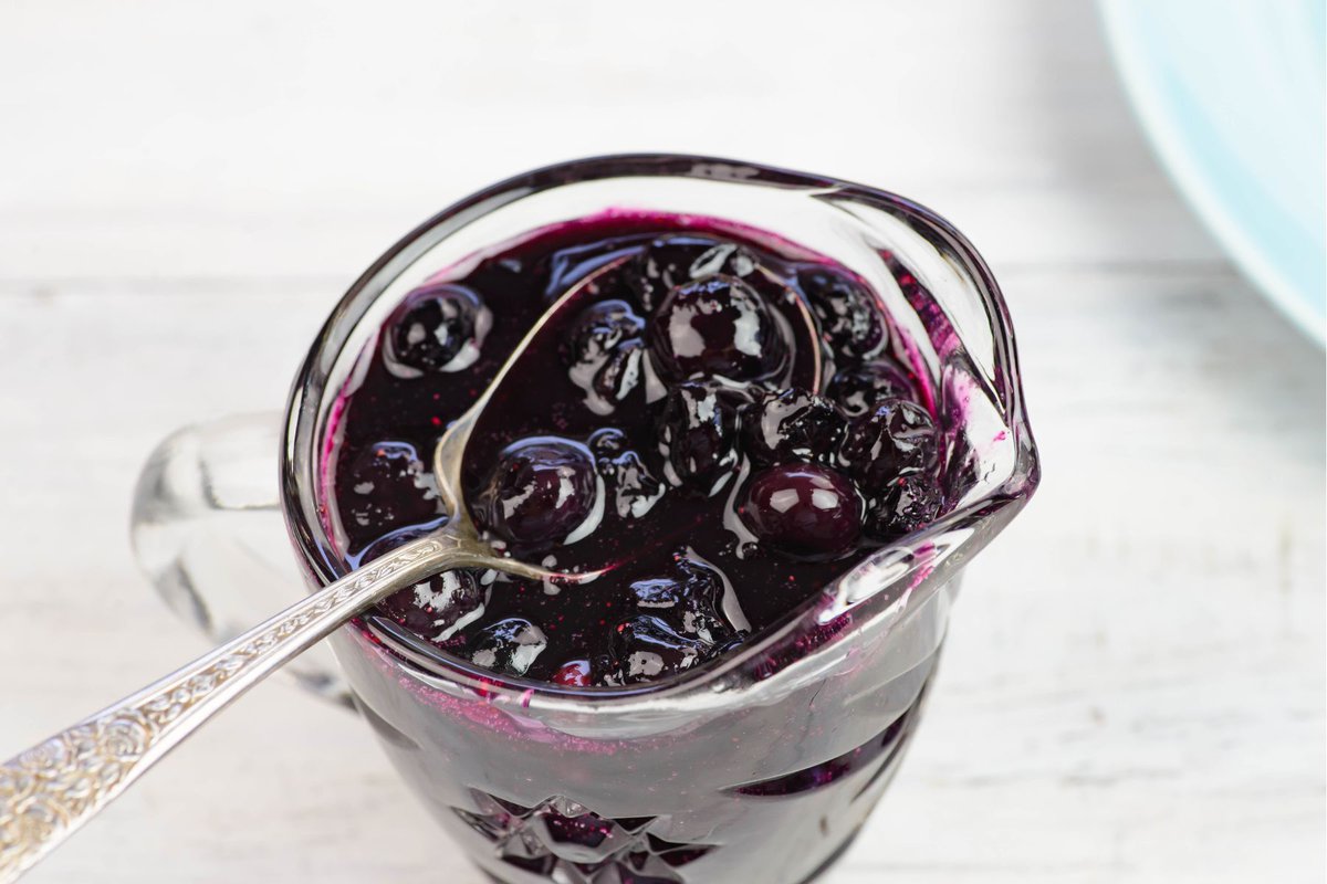 Blueberry fruit sauce on a spouted syrup container.