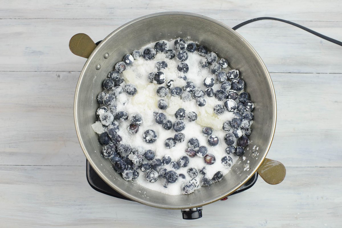 Cooking blueberries with sugar, corn starch and lemon juice in a low sauce pan.