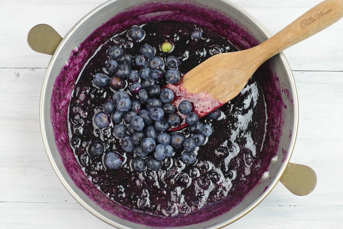 Adding whole blueberries to the blueberry sauce.