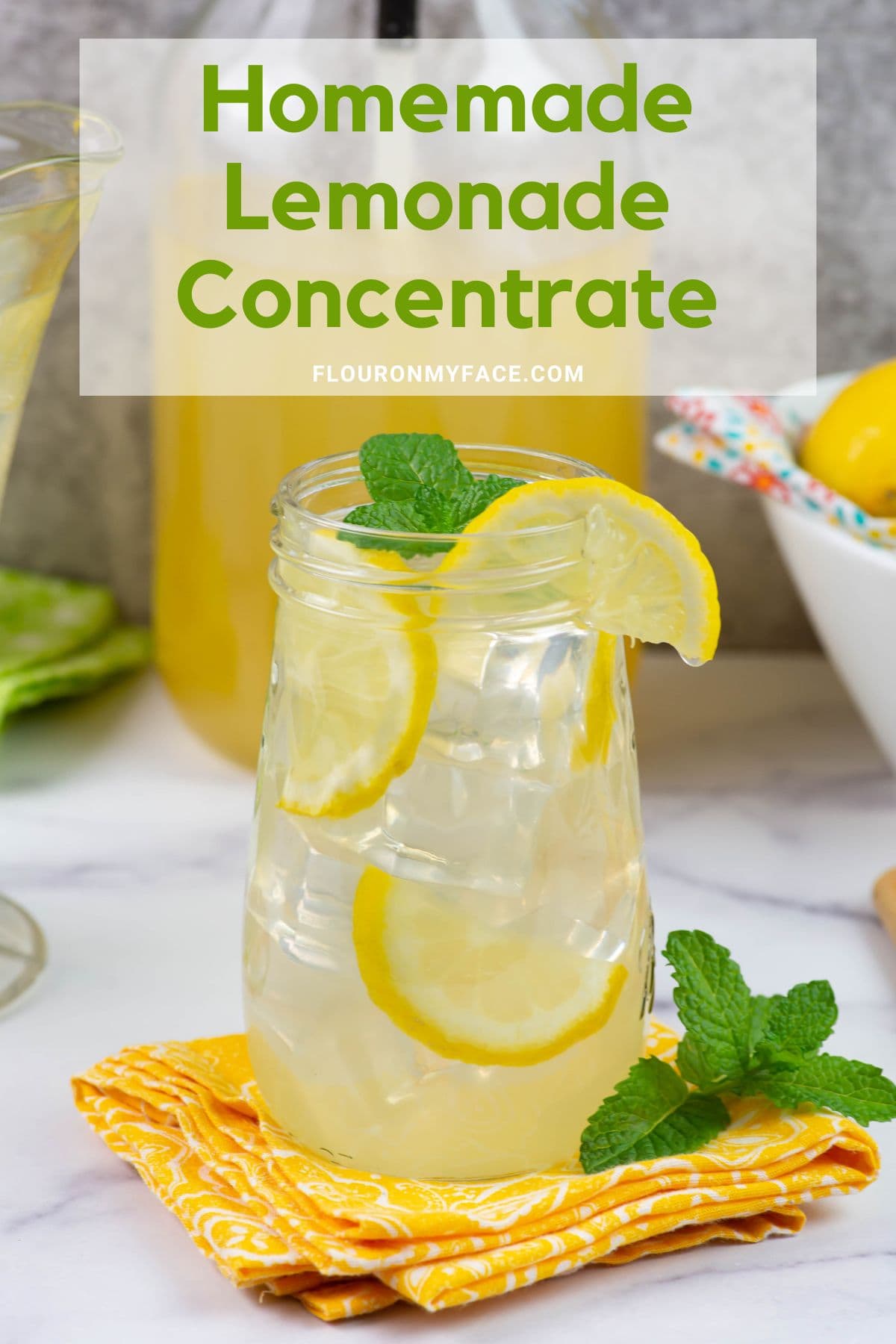 Glass of lemonade with mint and lemon garnish.