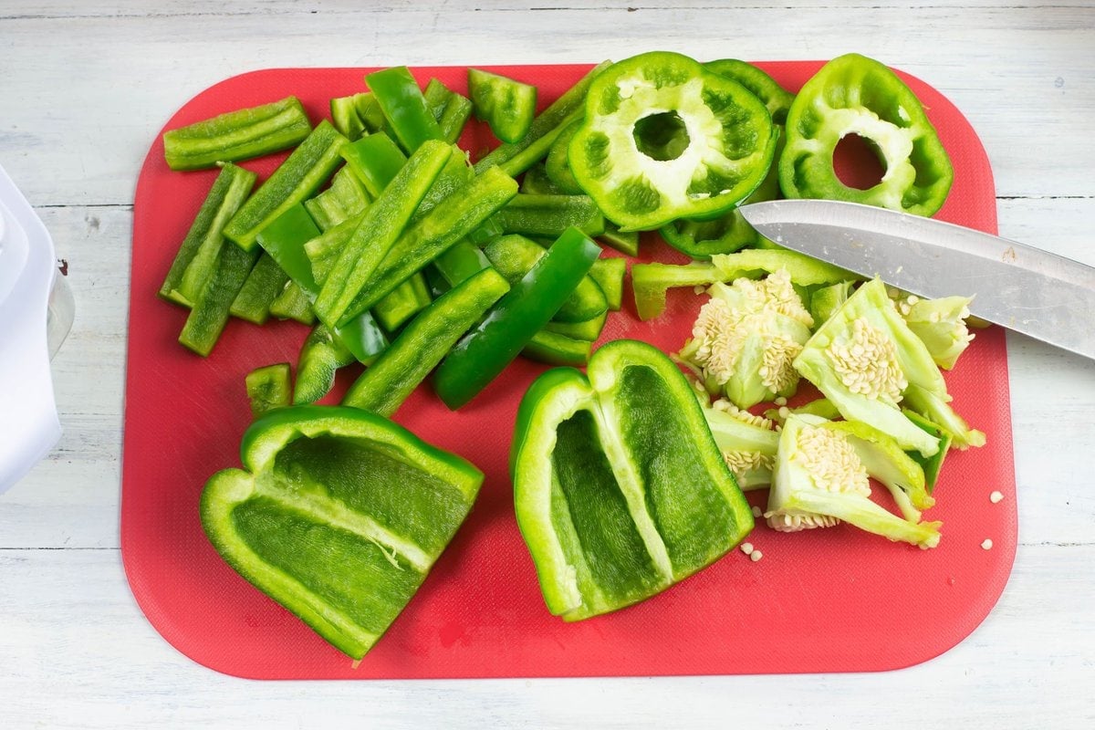 A green bell pepper cut in half, seeds and membrane removed.