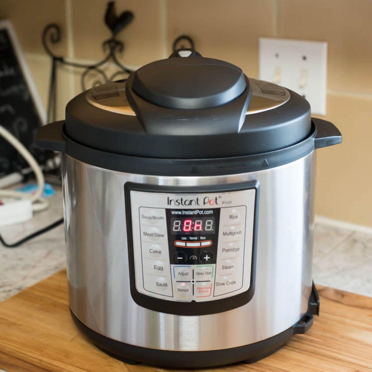 A 8 qt Instant Pot filled with ingredients for a recipe on a kitchen counter.
