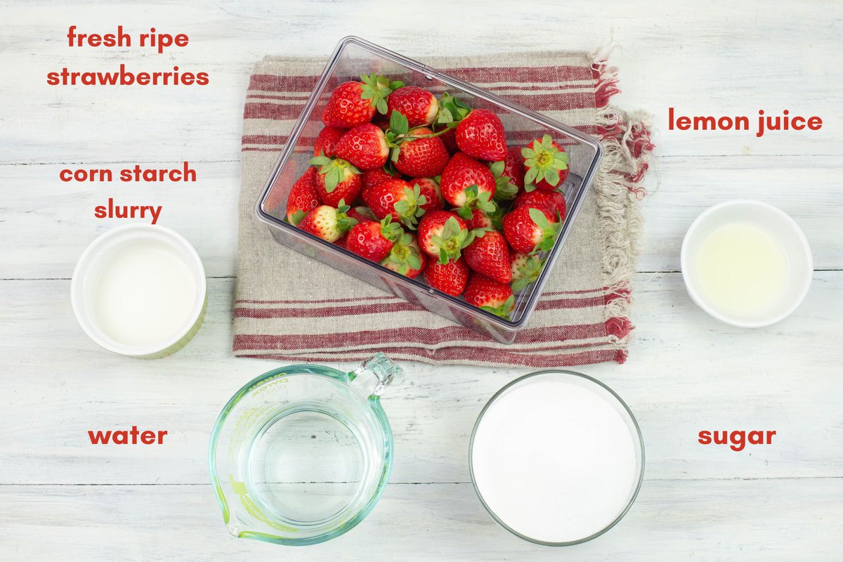 Homemade strawberry sauce ingredients in small bowls.